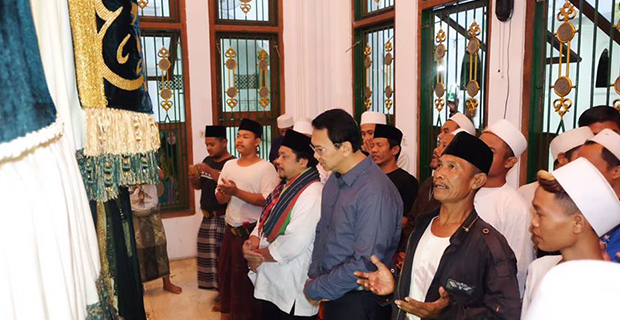 Ahok Duduk Bersila di Depan Makam Mbah Priok